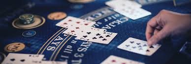 Multi-camera live-dealer table setup with professional croupier conducting blackjack game